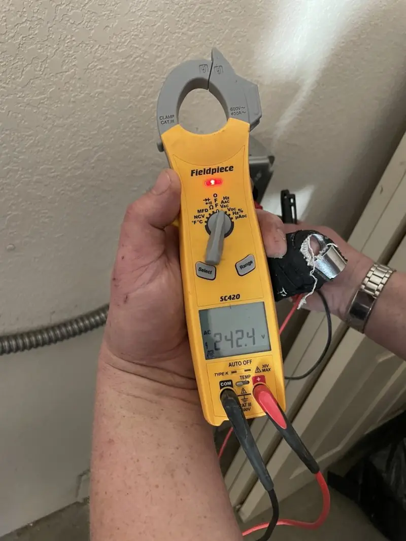 Voltage testing with clamp meter during Ceiling Fan Installation in Lincolnia